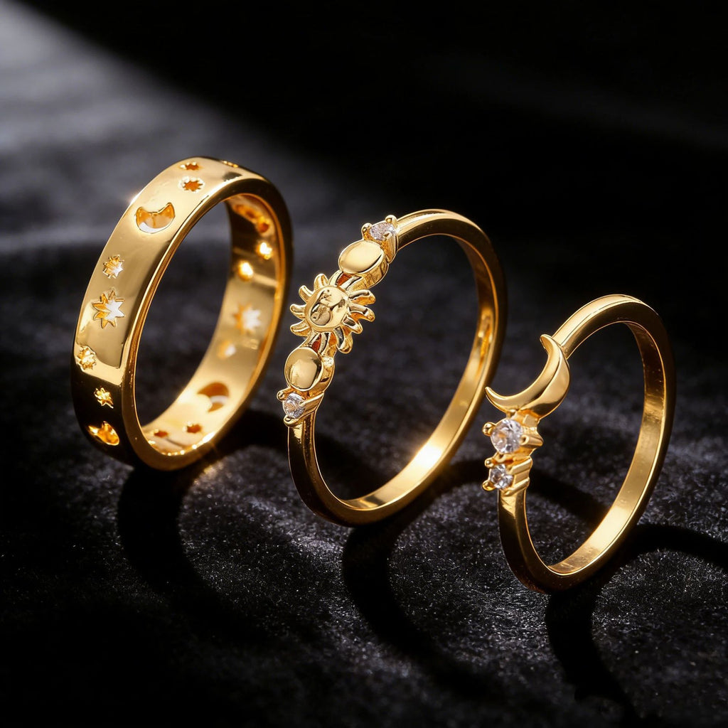 Three gold rings with intricate designs on a dark background