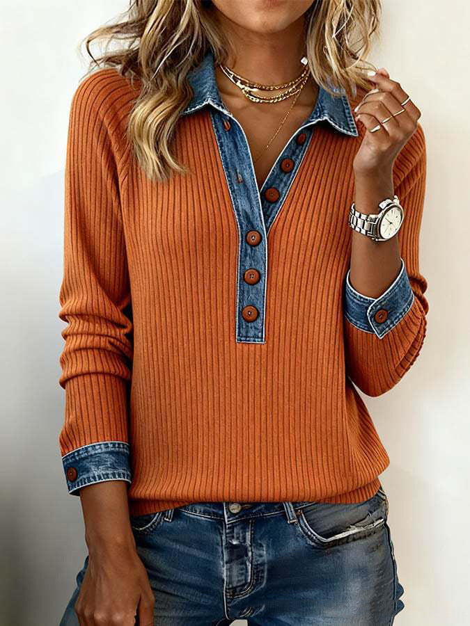 Orange sweater with denim collar and cuffs worn by a person against a neutral background