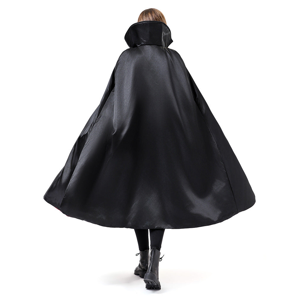 A person shown from the back wearing a large black hooded cape with a wide flowing silhouette, photographed against a plain white studio background.