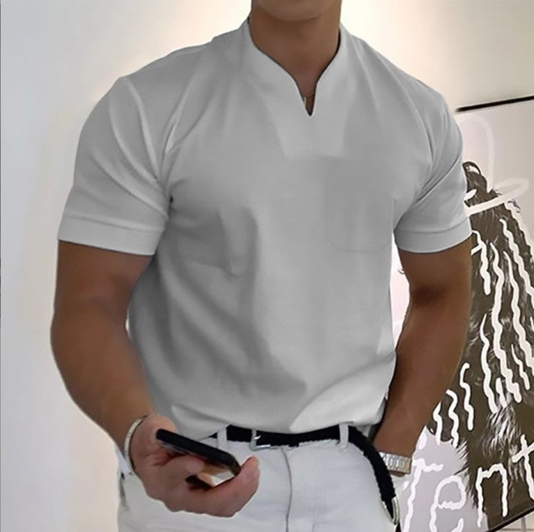 Person wearing a white shirt and white pants holding a phone.