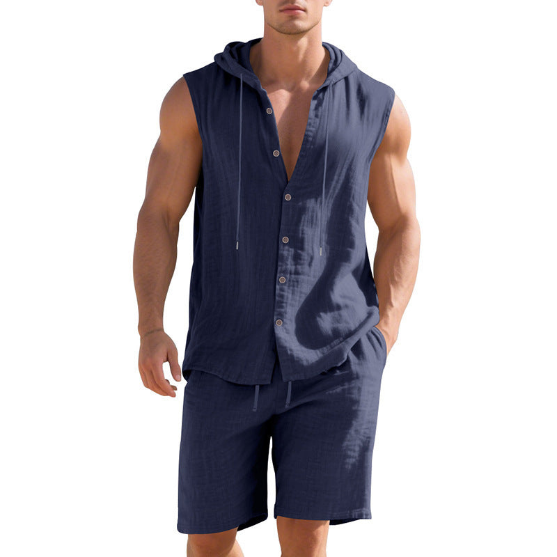 Man wearing a navy sleeveless shirt with buttons and shorts on a white background