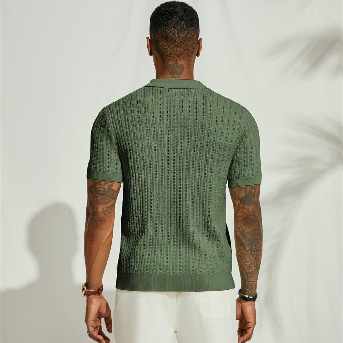 Person wearing a green textured shirt against a white background