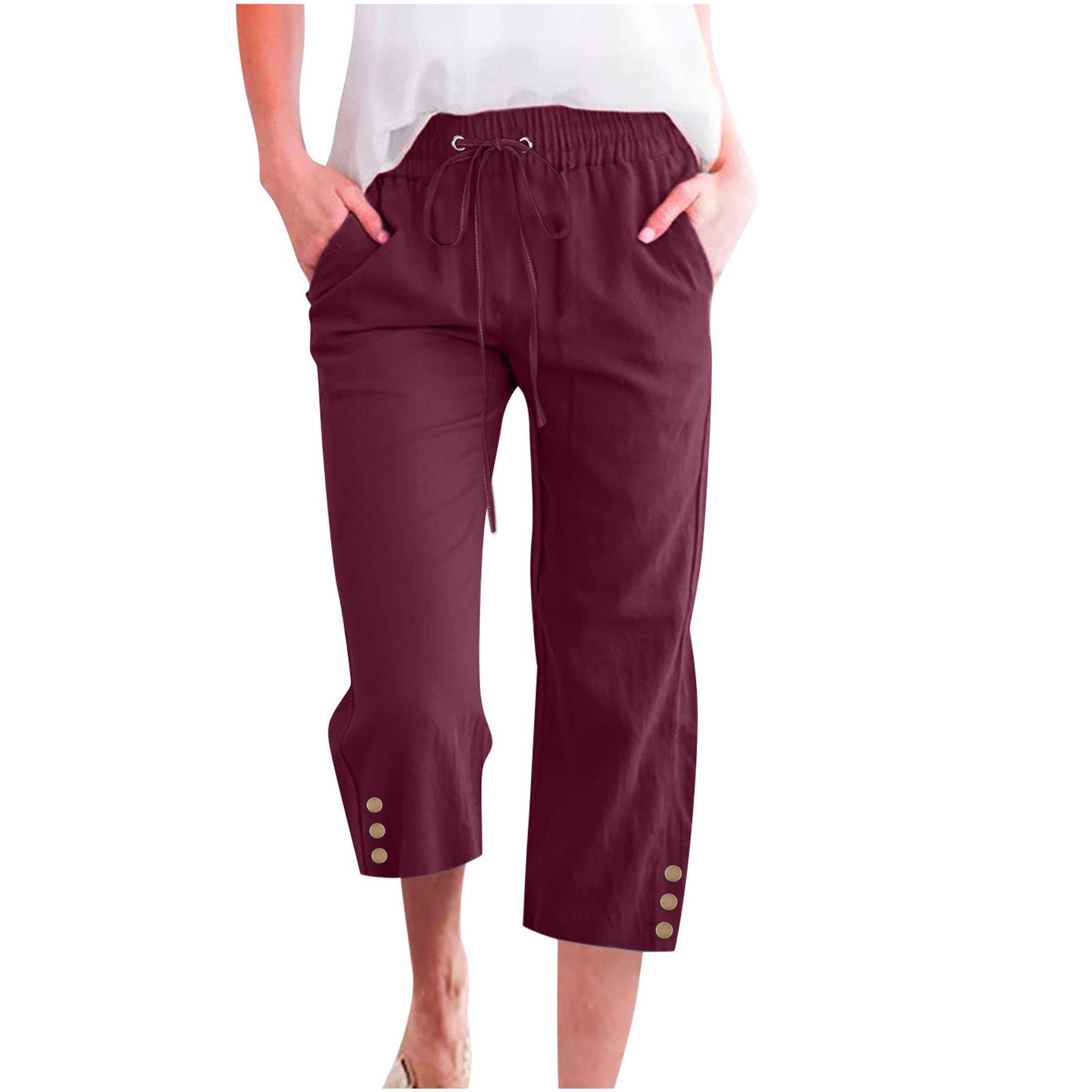 Maroon pants with gold buttons worn by a person on a white background