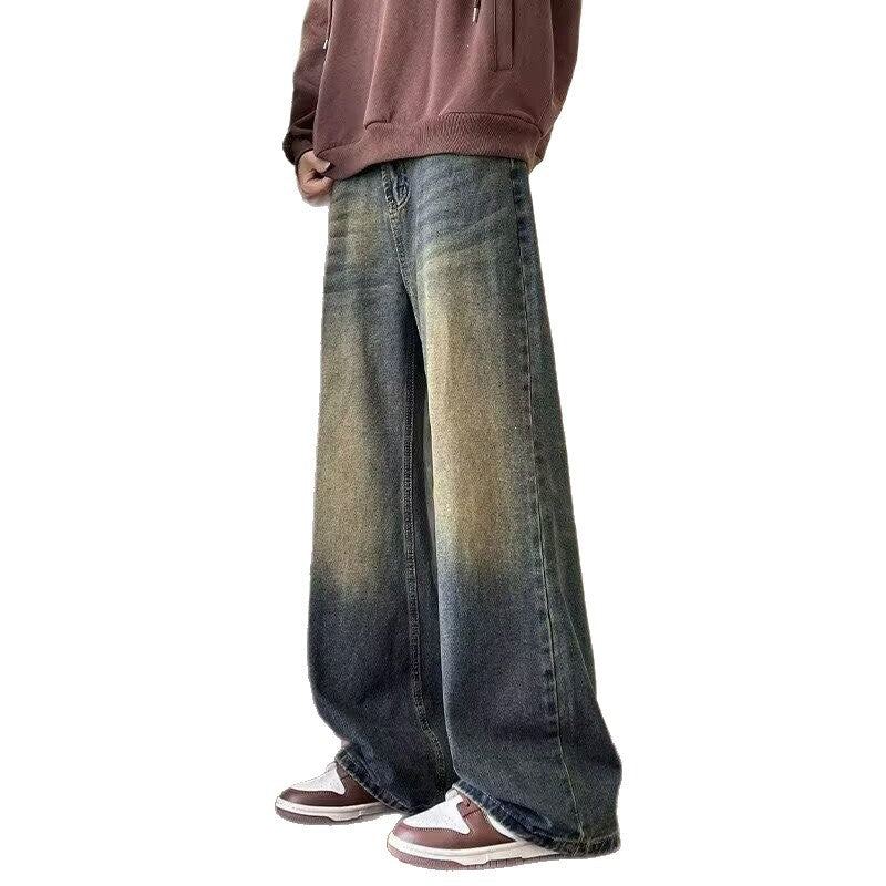 Person wearing wide-leg jeans and a brown hoodie on a white background
