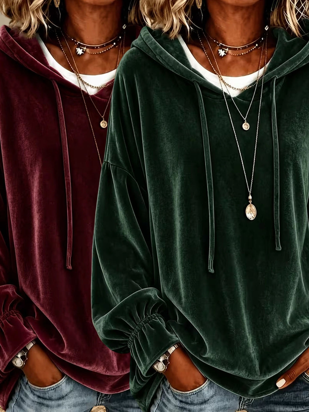 Two women wearing oversized velvet hoodies, one in deep burgundy and one in forest green, styled with layered necklaces and jeans.