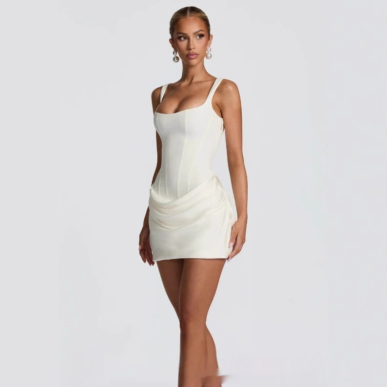 Woman wearing a white dress on a plain background