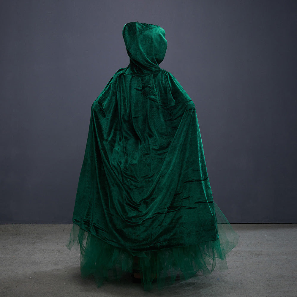 Green velvet dress with hood on a gray background