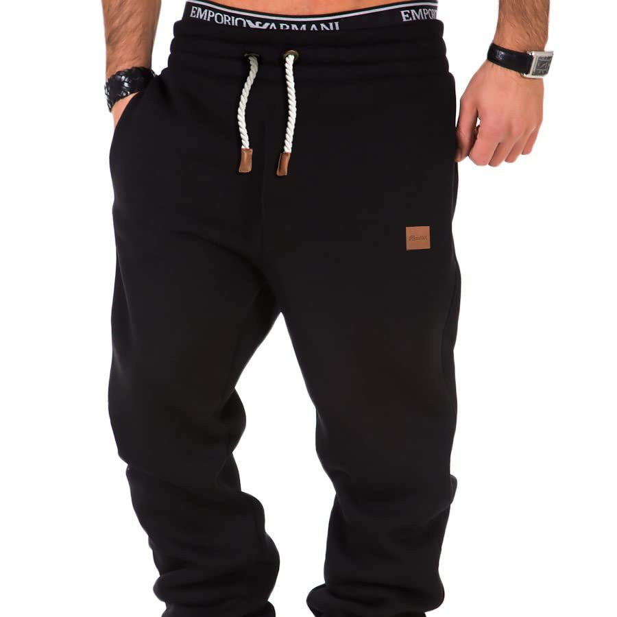 Black sweatpants with brand logo on a white background
