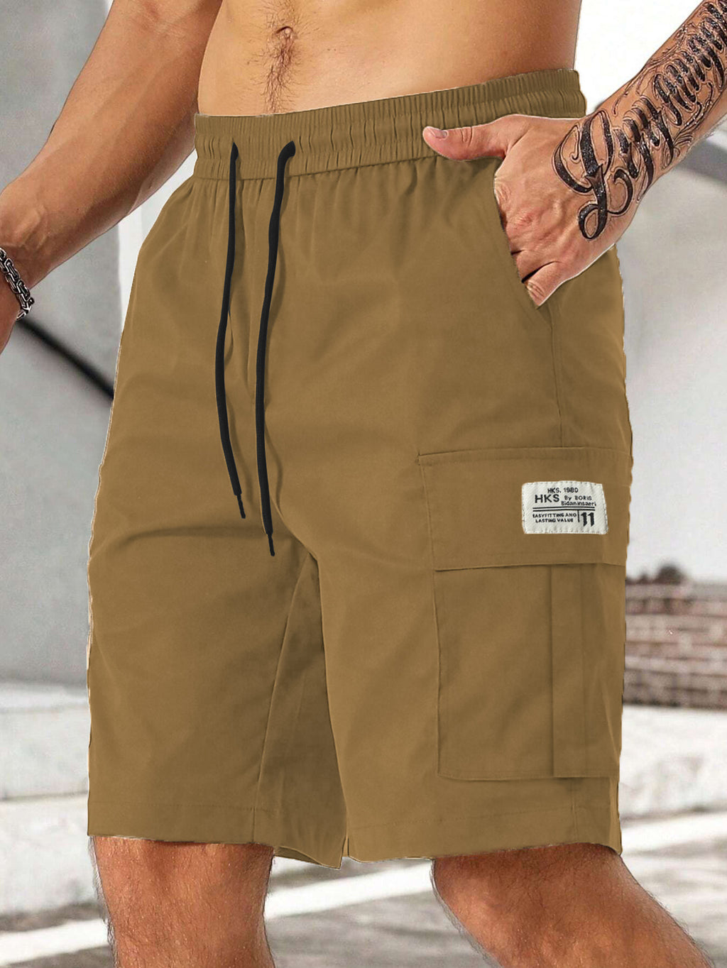 Brown shorts with a visible brand label worn by a person.