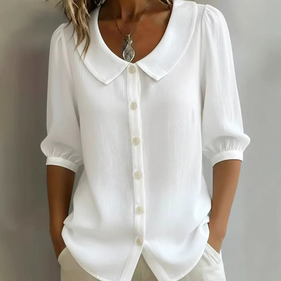 White blouse with a collar and buttons on a plain background