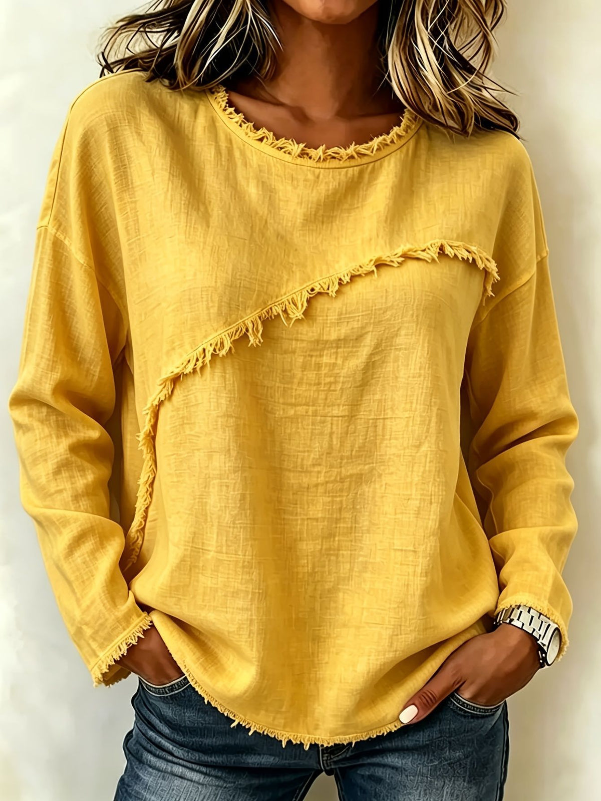 Yellow long-sleeve top with ruffled details worn by a person against a neutral background