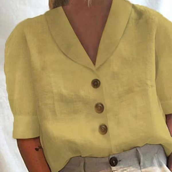 Yellow button-up top worn by a person on a white background