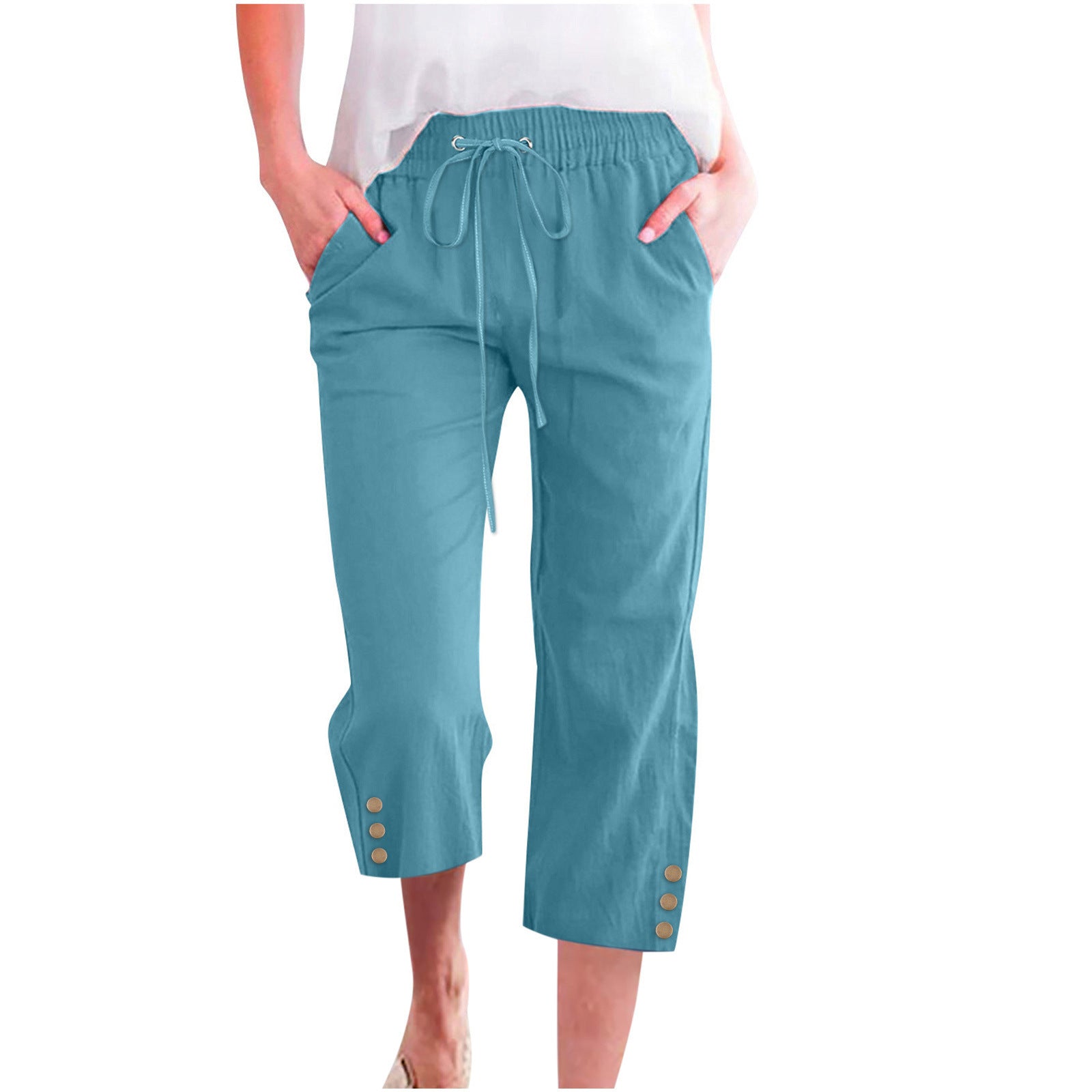 Teal capri pants with button details on a white background