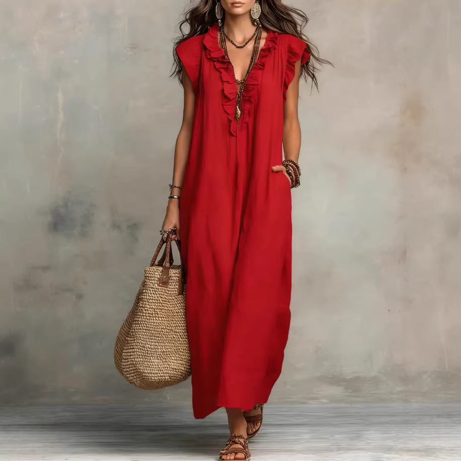 Woman wearing a red dress holding a straw bag against a neutral background