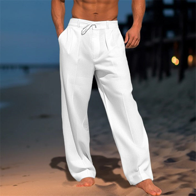 Person wearing white pants on a beach at night