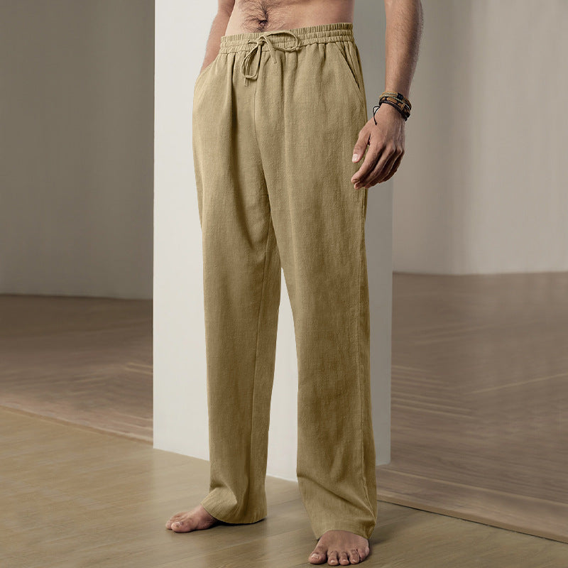 Person wearing beige linen pants in a minimalistic setting