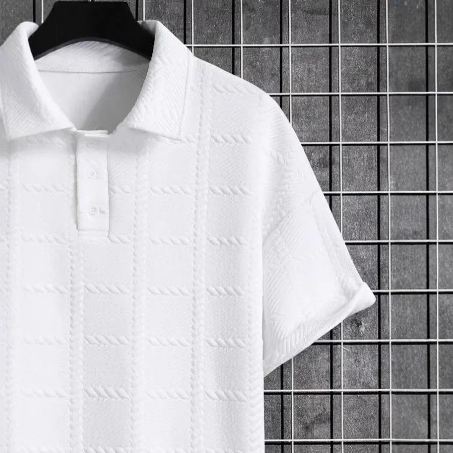 White textured shirt on a hanger against a tiled wall background