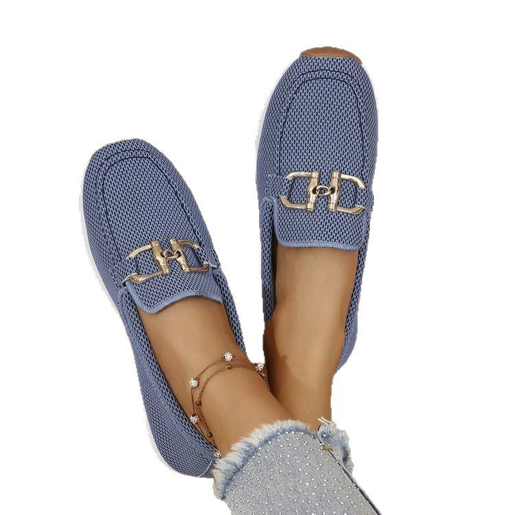 Blue textured loafers with gold logo on a white background