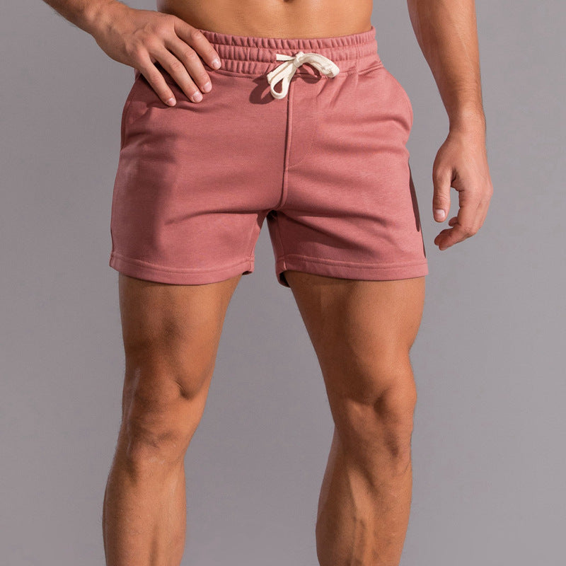 Person wearing pink shorts on a gray background