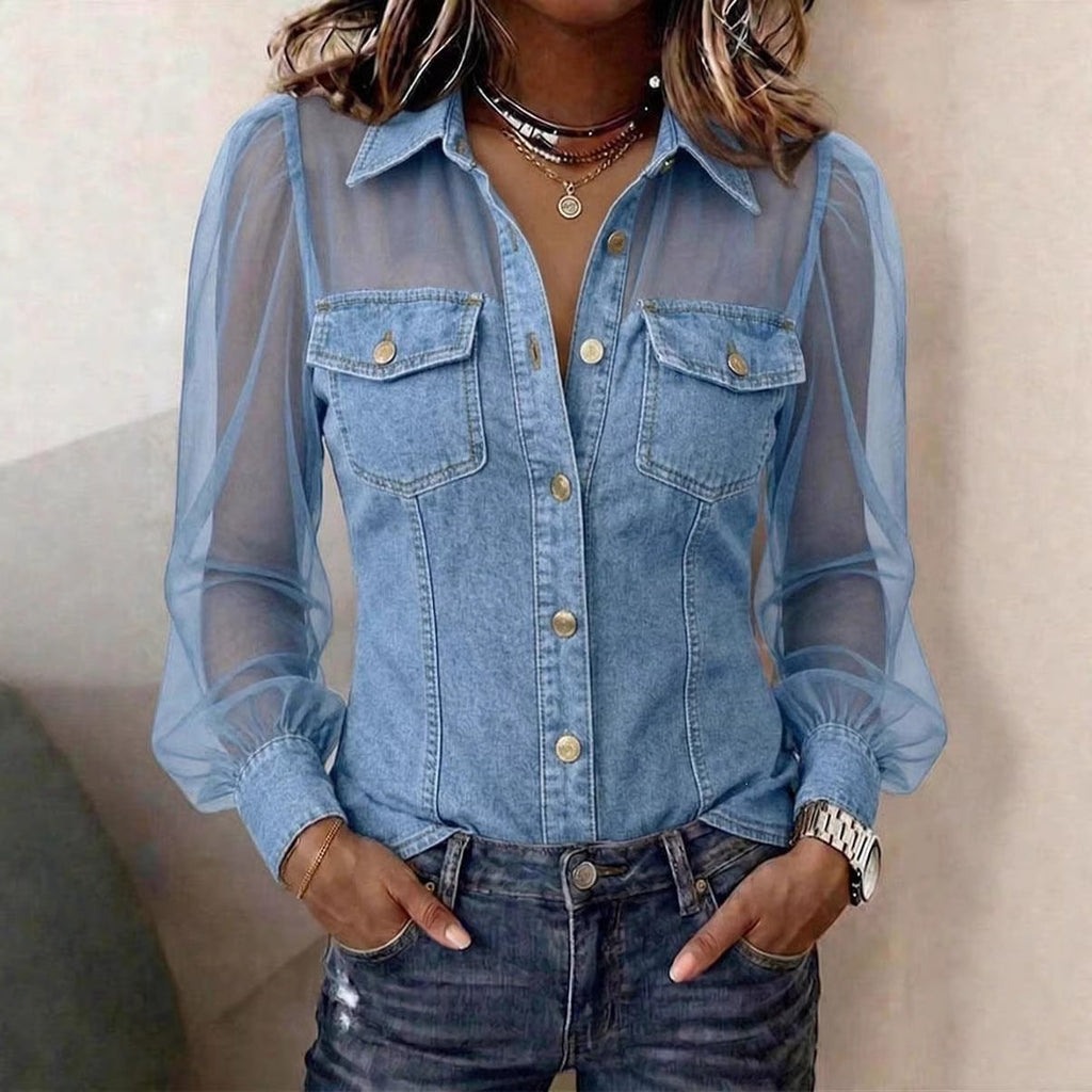 Person wearing a sheer blue denim shirt over a black top.