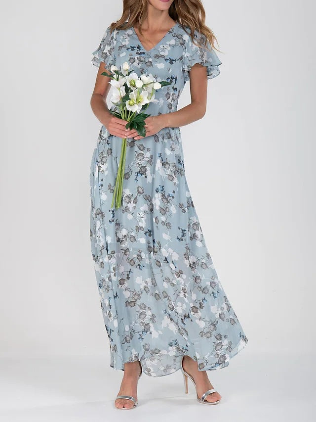 Woman wearing a light blue floral dress holding white flowers on a white background