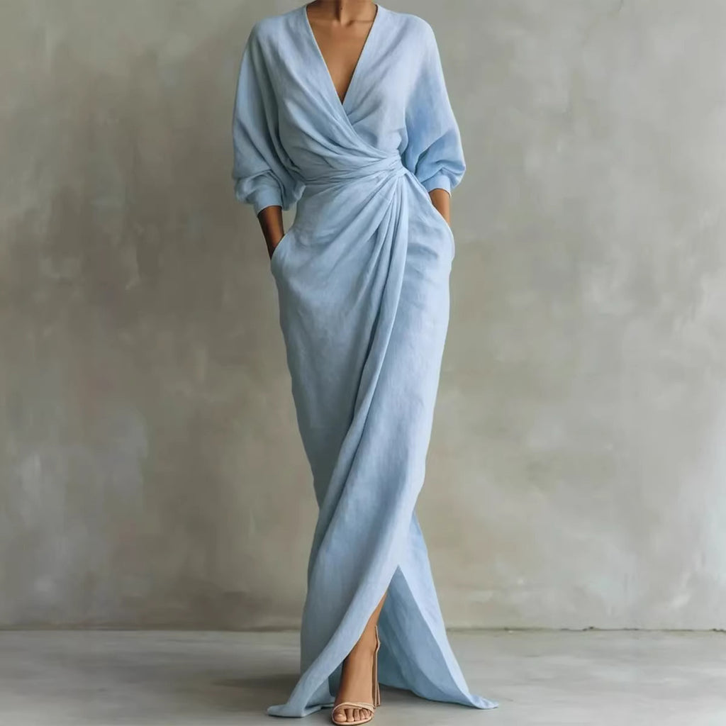 Light blue evening gown with a deep V-neck and a slit on a plain background