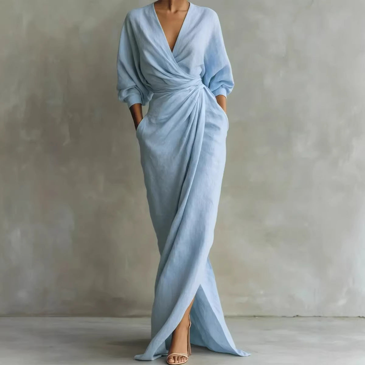 Light blue evening gown with a deep V-neck and a slit on a plain background
