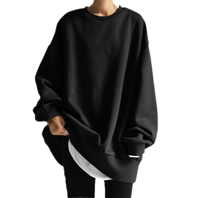 Black oversized sweatshirt worn by a person on a white background