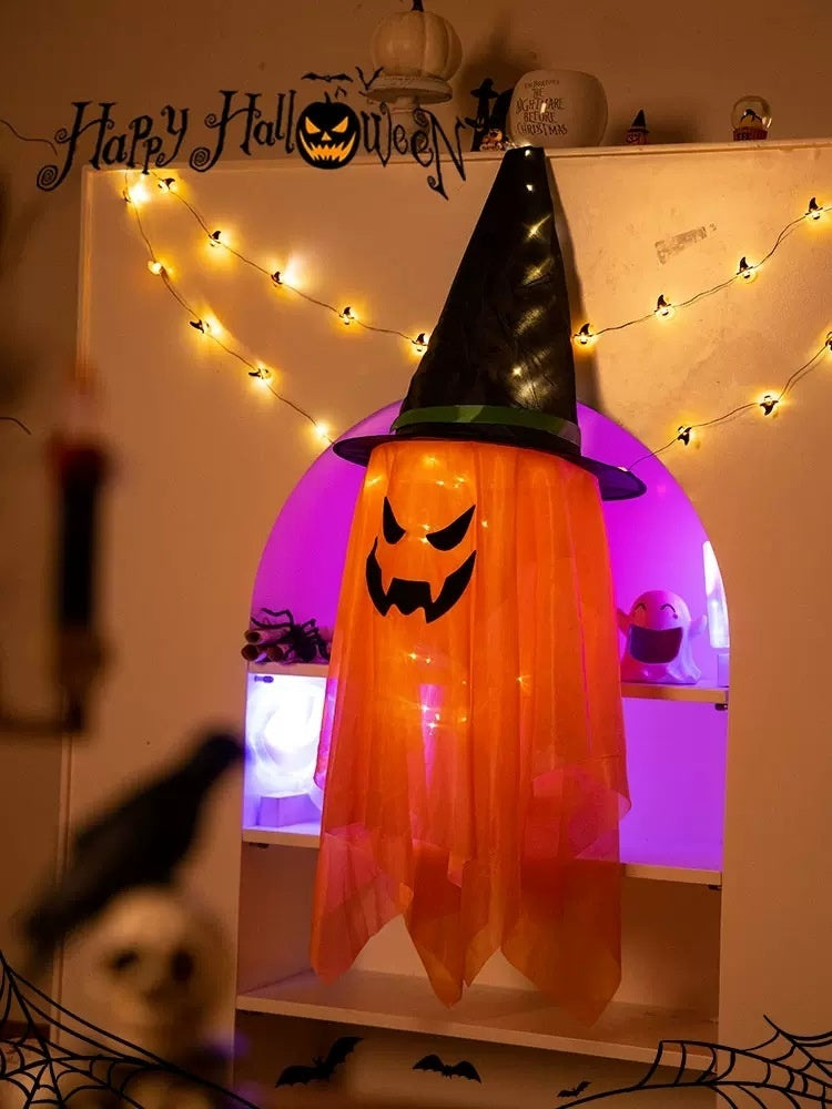 Halloween-themed decoration with a ghostly pumpkin figure and string lights.