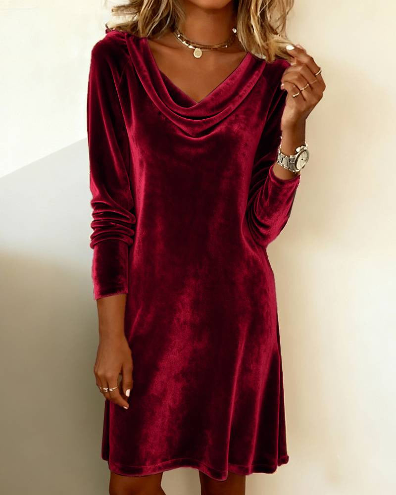 Red velvet dress worn by a person on a plain background