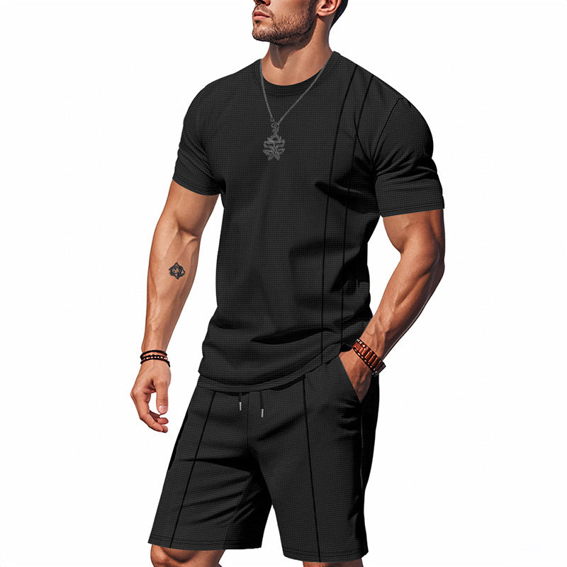 Man wearing a black athletic outfit on a white background
