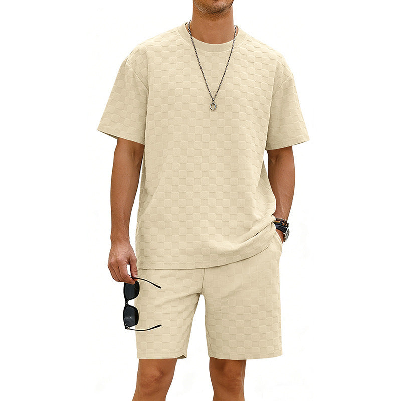 Man wearing a beige t-shirt and shorts set on a white background