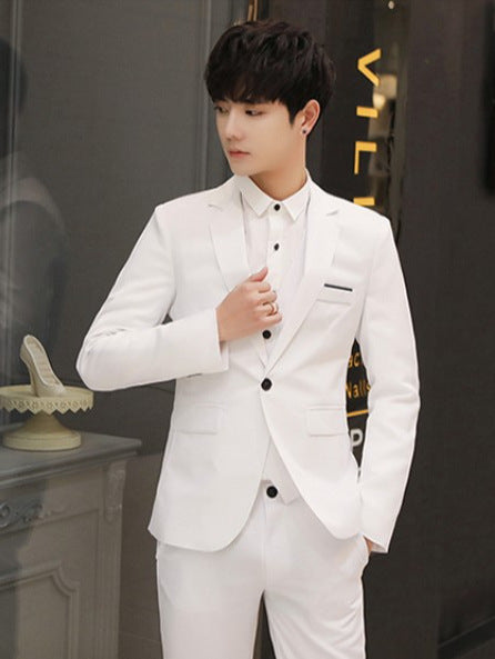 Person wearing a white suit in an indoor setting