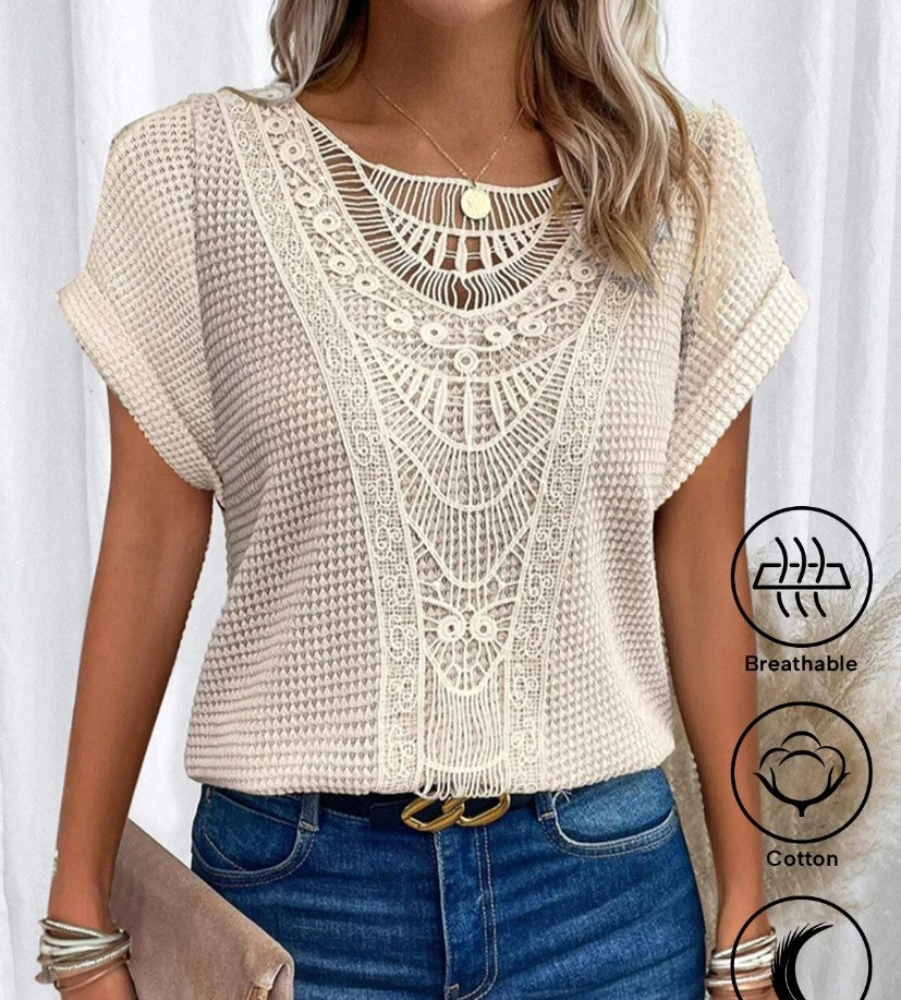 Woman wearing a beige crochet top with a white background
