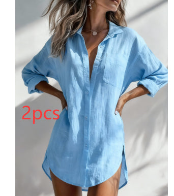 A woman wearing an oversized light blue button-up shirt with rolled sleeves and a relaxed fit, shown against a sunlit white wall. Red text on the image reads '2pcs'.