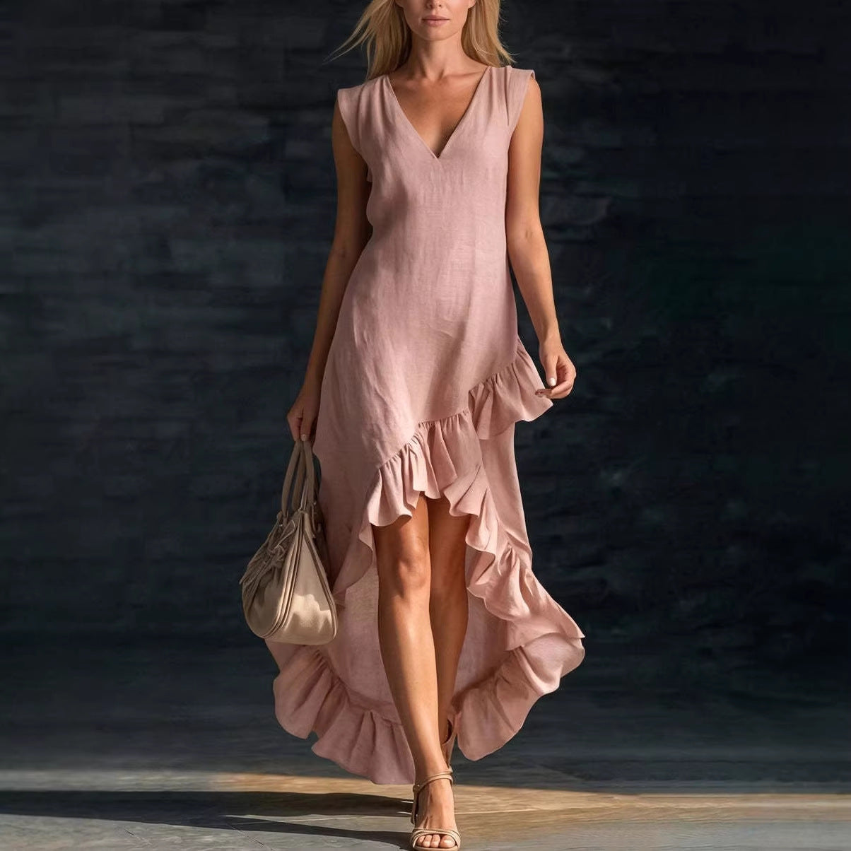 Woman wearing a pink dress with ruffles against a dark background