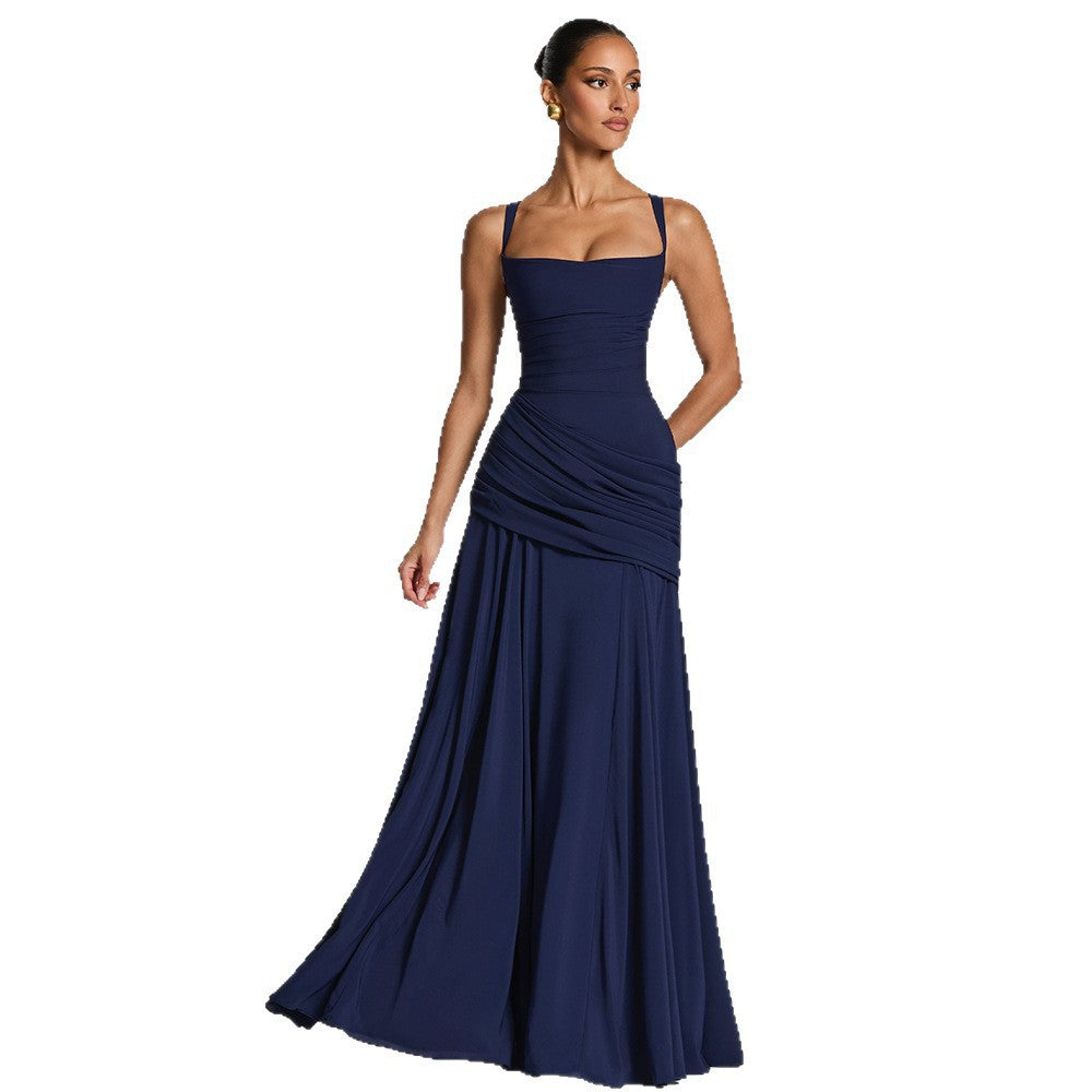 Woman wearing a navy blue evening gown on a white background