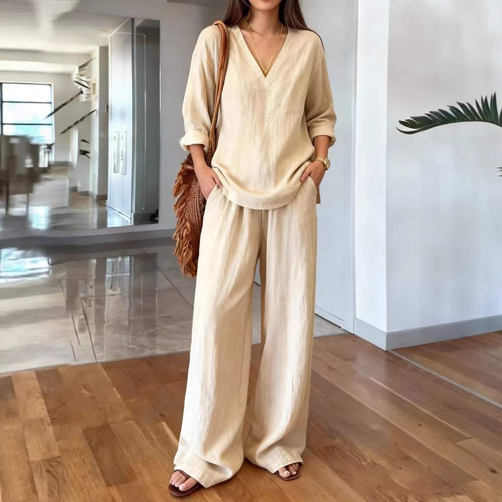 Woman in beige outfit standing in a modern indoor setting