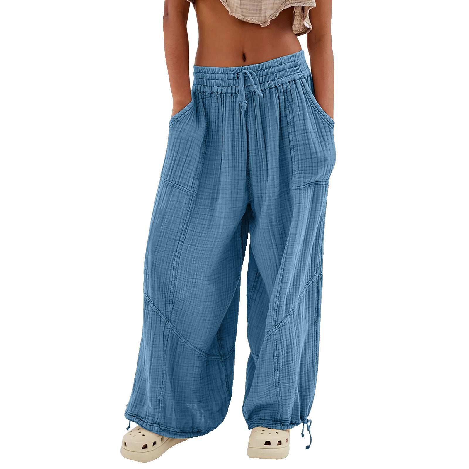 Blue wide-leg pants worn by a person on a white background