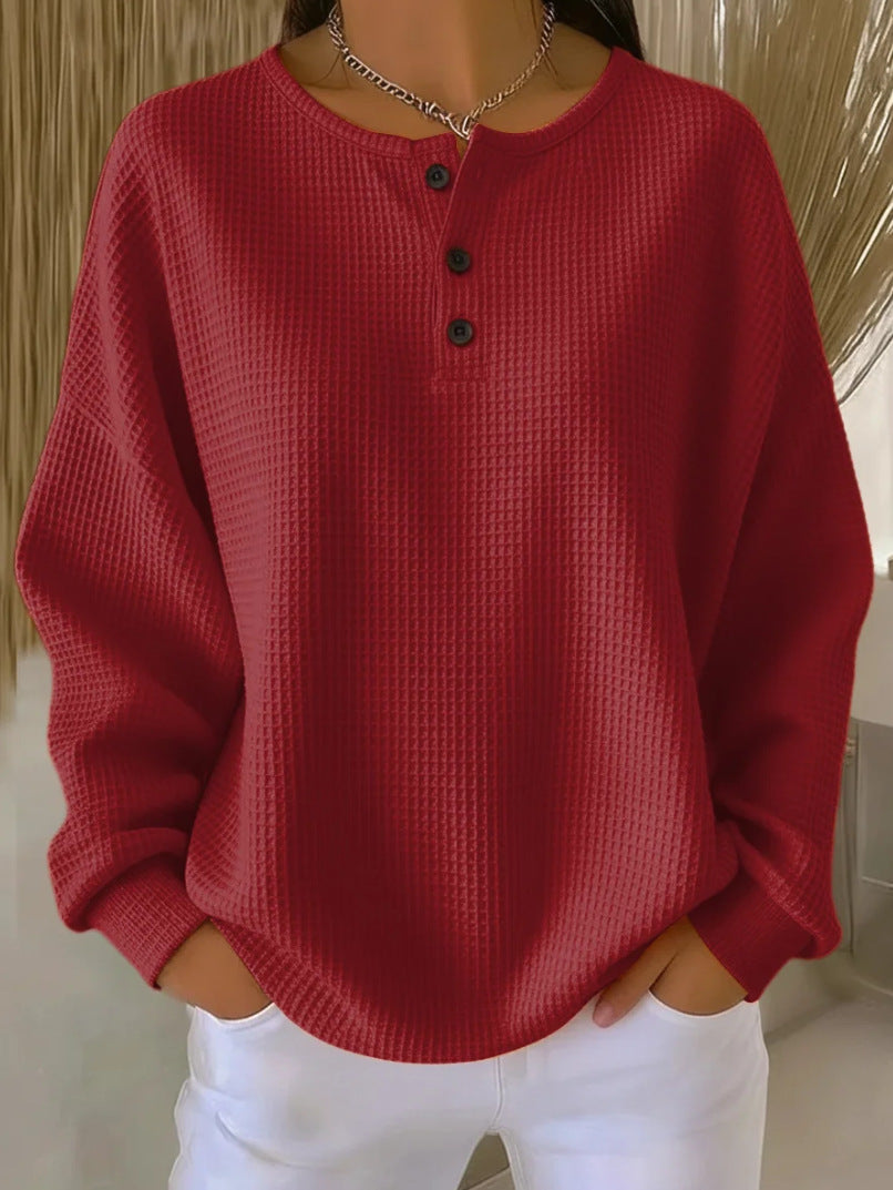 Red textured sweater worn by a person with a neutral background