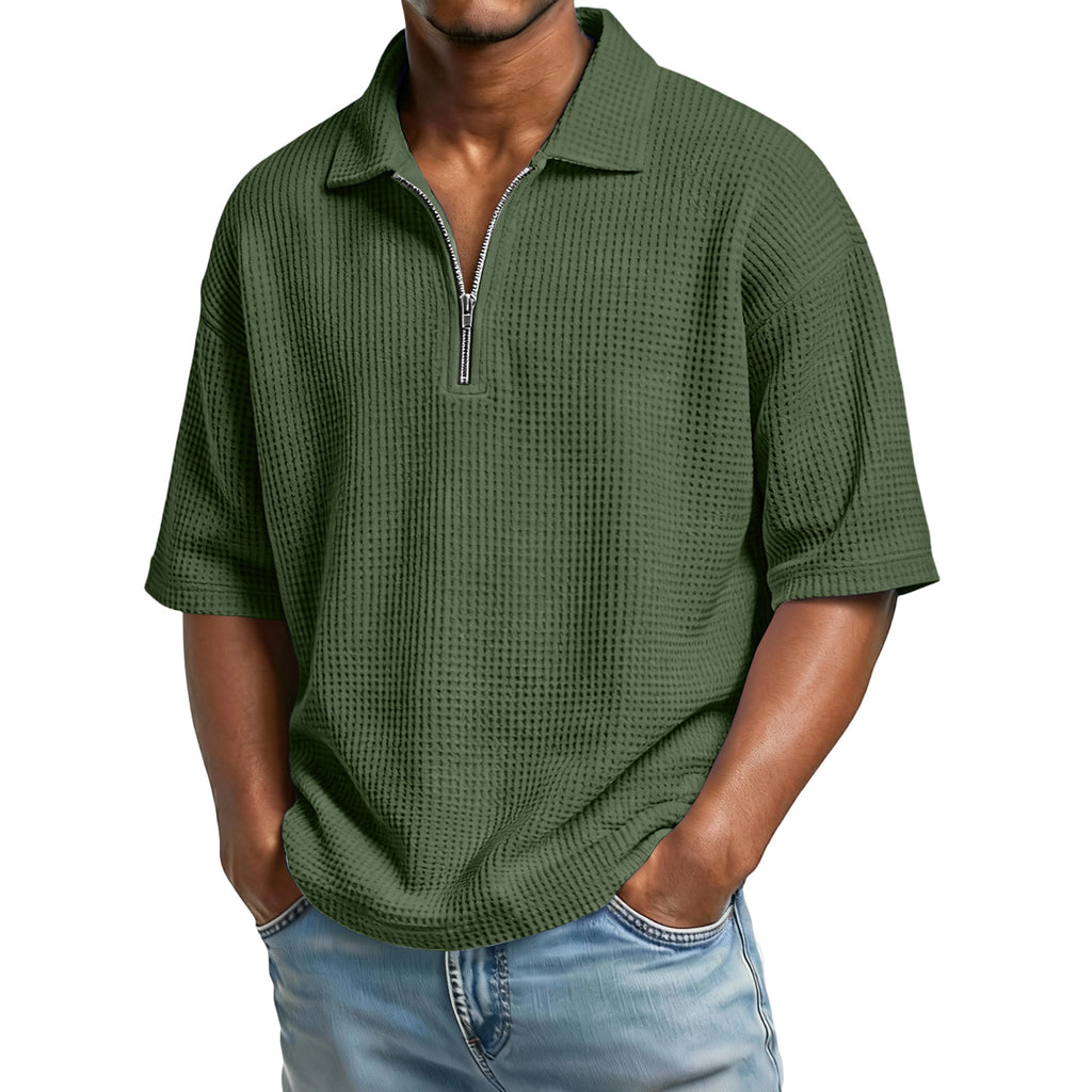 Man wearing a green textured short-sleeve shirt with a zipper on a white background