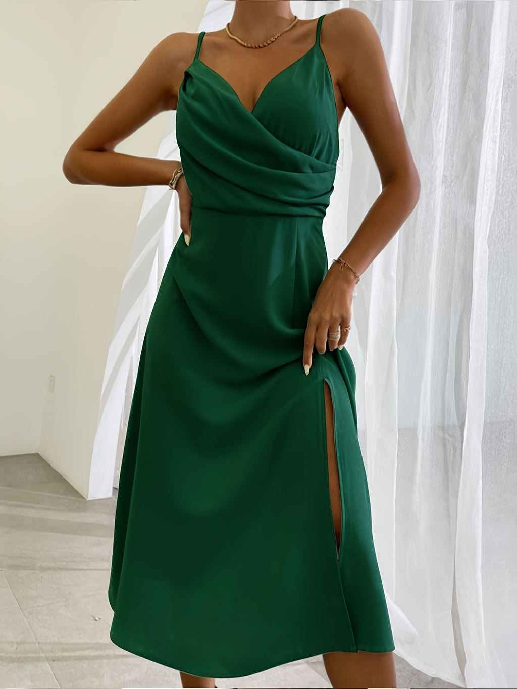 Green dress with a slit on a white background