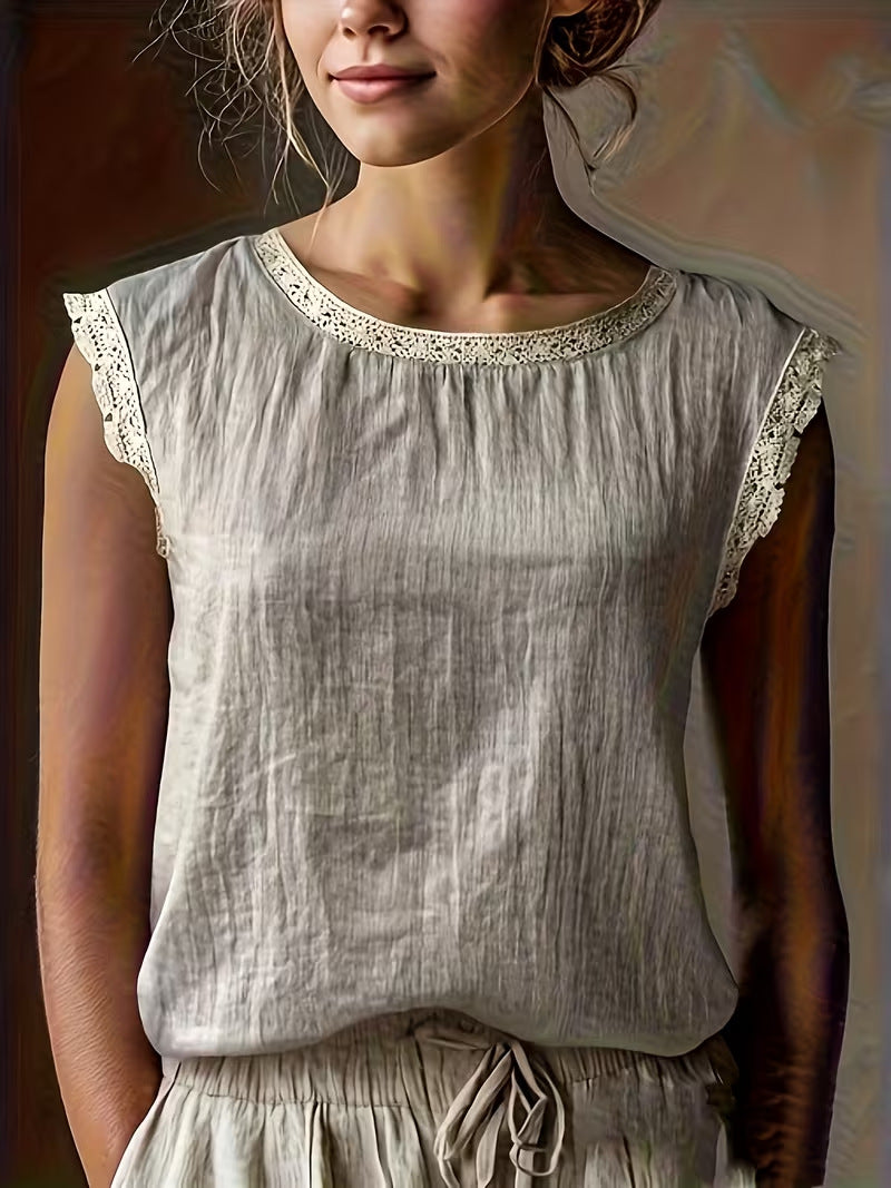 Woman wearing a light gray sleeveless top with lace trim
