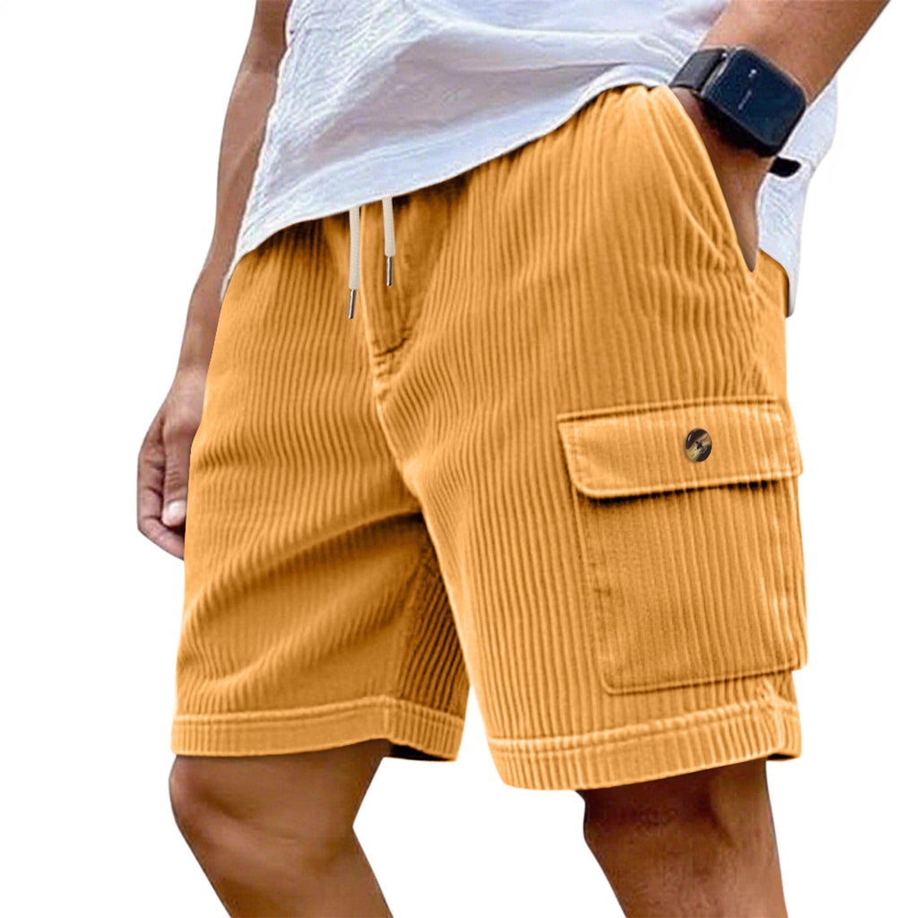Mustard yellow corduroy shorts worn by a person on a white background