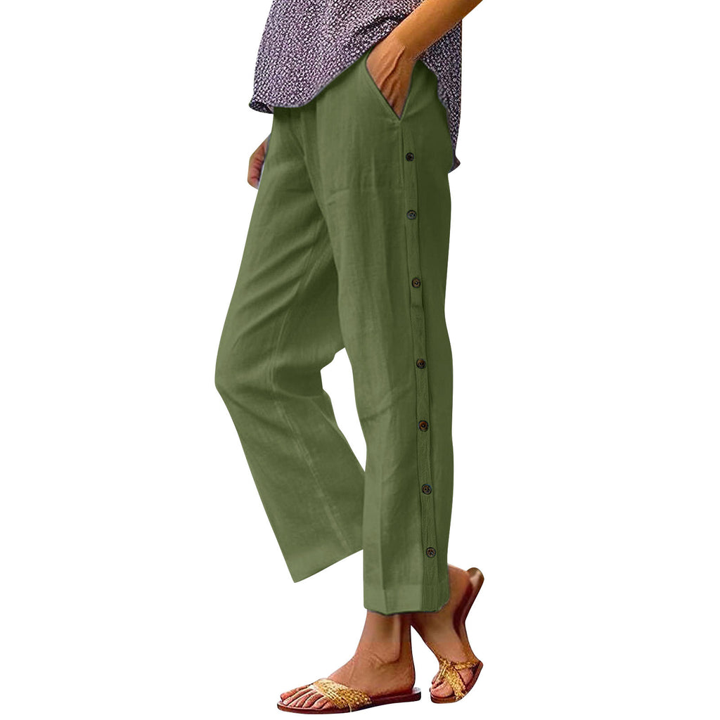 Green pants with buttons worn by a person on a white background