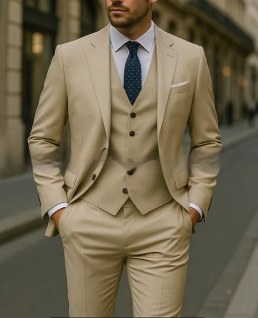 Man wearing a beige suit with a blue patterned tie on a blurred street background
