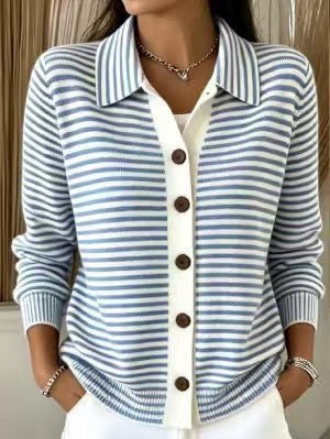 A woman wearing a blue and white striped knit cardigan with a white button placket and dark brown buttons, layered over a white top.