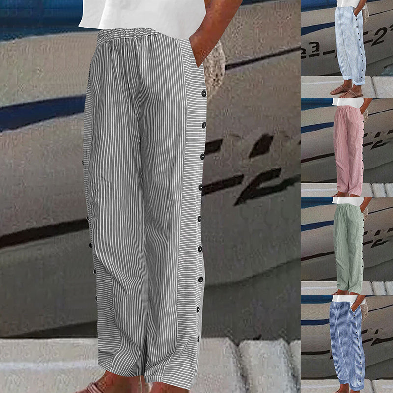 Striped pants with buttons worn by a person, displayed against a boat background.