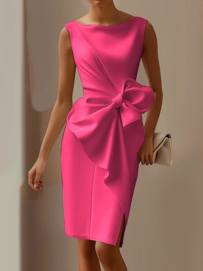 Pink dress with a large bow detail on a neutral background