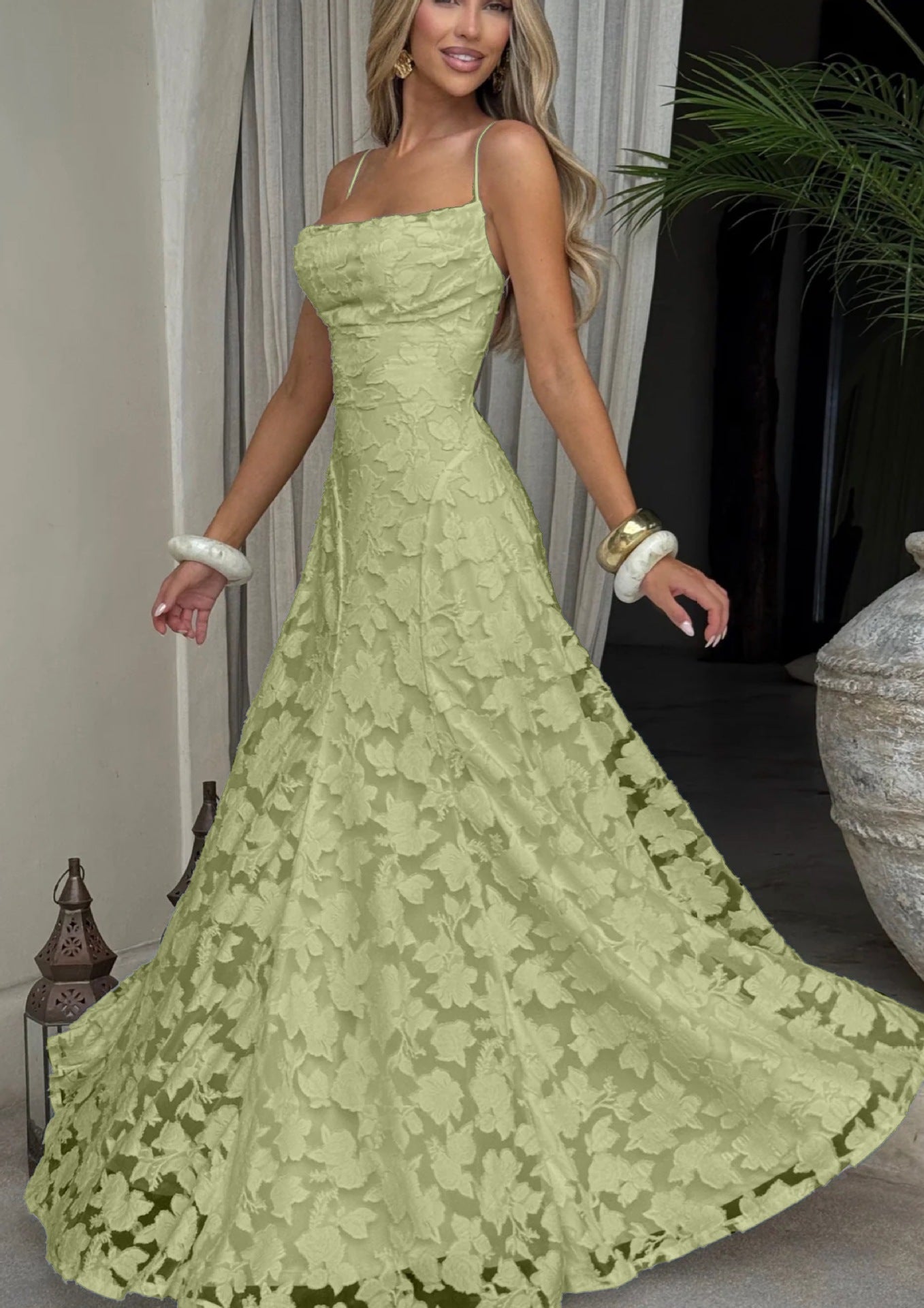 Woman wearing a green lace dress in an indoor setting